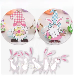 Detail showing painted wooden Easter gnome and rabbit pendants with hanging strings