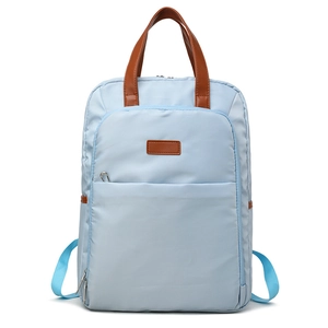 Minimalist light blue nylon backpack with brown leather handle and front zipper pocket