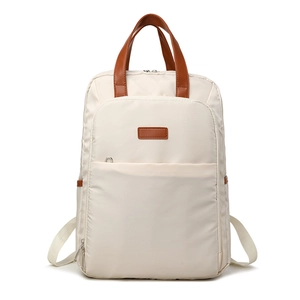 Minimalist beige backpack with brown leather handles and large storage capacity