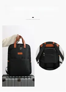 Detail of the back trolley sleeve on black nylon backpack secured to suitcase handle