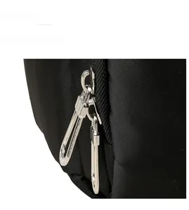 Close-up of smooth metal double zippers on a water-resistant black backpack fabric