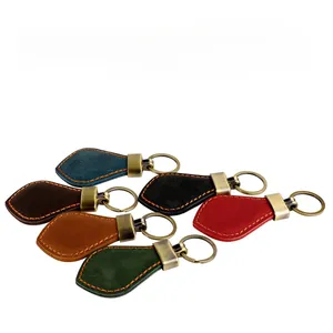 Close-up of vintage leather keychains in six colors with orange contrast stitching