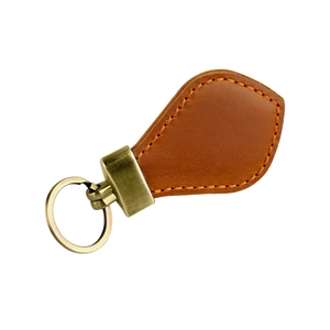 Detail of vintage brown leather keychain with bronze ring and orange stitching