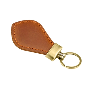 Detail of drop-shaped brown crazy horse leather keychain with vintage brass metal buckle