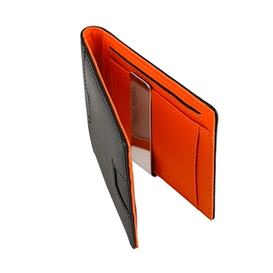 Detail of slim leather RFID wallet showing interior orange contrast and metal money clip