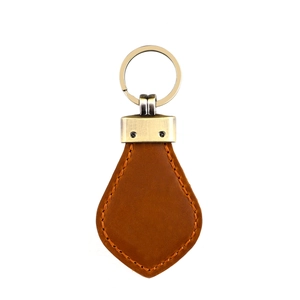 Detail of vintage brown crazy horse leather keychain with orange stitching and bronze ring