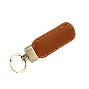 Detailed view of vintage brown crazy horse leather keychain with orange stitching and brass ring