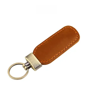 Detail of vintage crazy horse leather keychain with brown finish and manual orange stitching