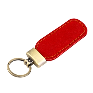 Detail of red crazy horse leather car keychain with vintage bronze hardware and stitching
