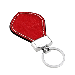 Close-up of red lychee grain leather keychain with silver metal ring and white stitching