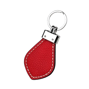 Detail of red pebble leather keychain with white contrast stitching and silver hardware