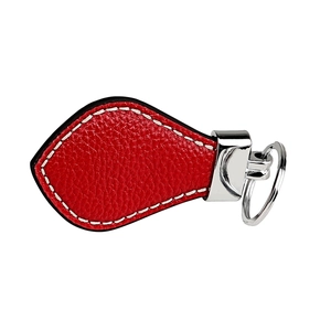 Detailed close-up of red lychee grain leather keychain with durable white stitching