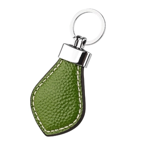 Detailed view of green lychee leather keychain with white stitching and silver metal ring