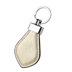 Detailed view of champagne leather teardrop keychain with polished silver metal ring