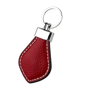 Detailed macro view of a premium red leather heart-shaped keychain with silver ring.