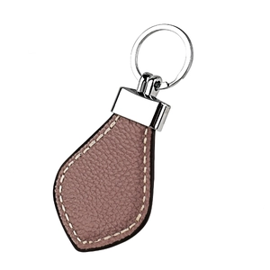 Detailed macro view of heart shaped pink leather keychain with premium lychee grain texture