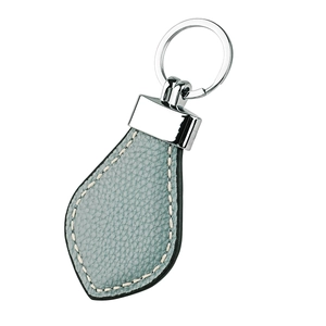 Macro detail of light blue lychee pattern leather keychain with neat white stitching