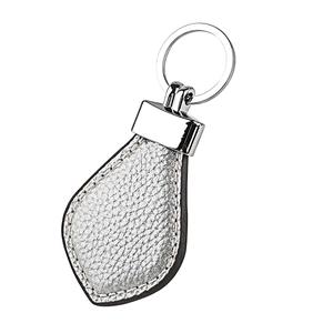 Detail of silver lychee grain leather teardrop keychain with white contrast stitching