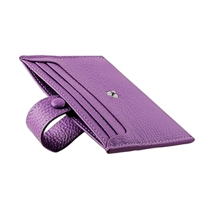 Detailed macro view of purple pebble grain leather card holder with secure metal snap button
