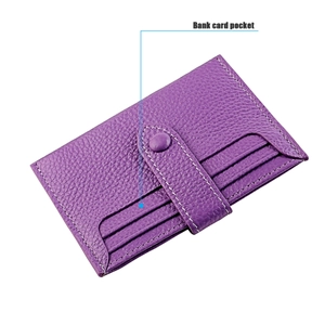 Detail of purple lychee grain leather card holder with secure snap closure and card pockets