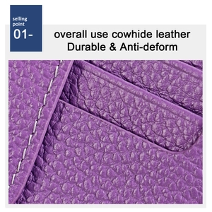 Detail of purple lychee grain cowhide leather with durable white contrast stitching