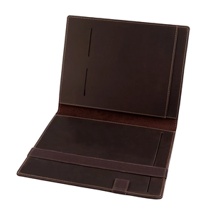Detailed macro view of dark brown leather notebook cover with card slots and elastic strap