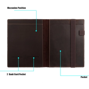 Detail of vintage leather notebook cover with card slots, pen holder and elastic band