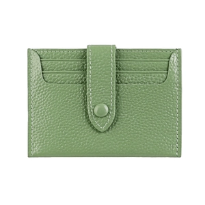 Detail view of grass green litchi grain leather card holder with three card slots and button