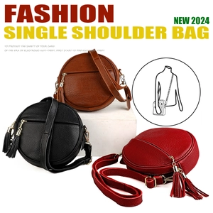 Detailed view of three circular pebble grain leather crossbody bags with tassel zippers