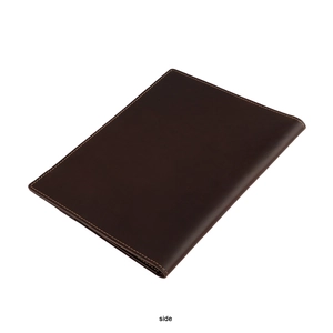 Side view of dark brown leather A5 notebook cover with yellow stitching detail