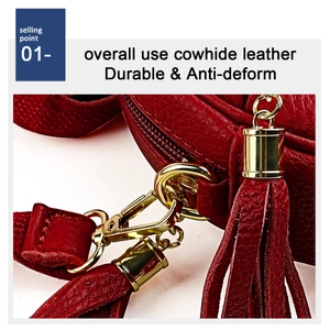 Detail of durable cowhide leather texture with gold metal hook and stylish fringe tassel