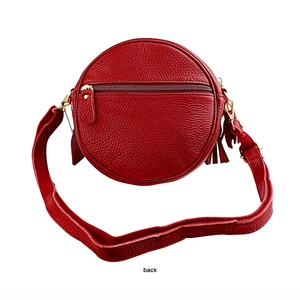 Back view of round red leather crossbody bag with tassel and gold zipper pocket