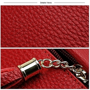 Macro detail of red litchi grain cowhide leather with golden tassel and chain hardware