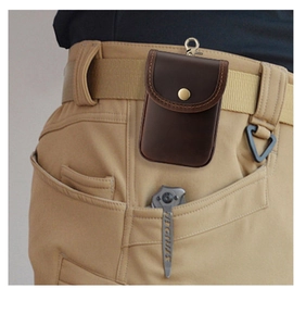 Detail of crazy horse leather waist bag with metal snap button and carabiner hook