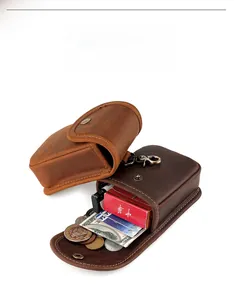 Detail view of leather belt pouches showing storage for cigarettes, coins and lighters