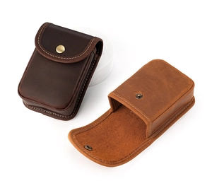 Detail of vintage crazy horse leather belt pouch with metal snap button closure