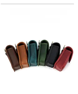 Group of vintage leather pouches in six colors with metal hooks on white background