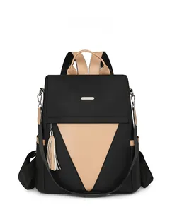 Close-up of women's nylon backpack with contrast color panel and tassel detail