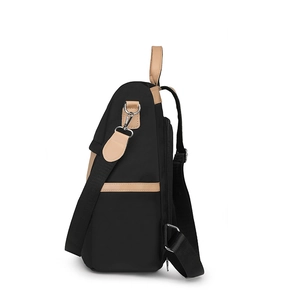 Side view of nylon travel backpack with brown leather trim and silver metal hardware