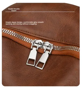 Makro-Detail von glatten Doppel-Silberreißverschlüssen und braunem Leder am Mode-Rucksack
