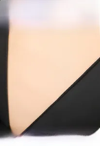Detail of beige faux leather and black twill fabric stitching on a large travel backpack