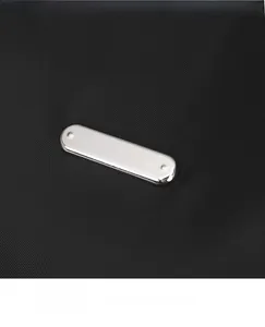 Detail of silver rectangular metal hardware on premium black nylon fabric texture