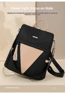 Detail of a large capacity anti-theft nylon backpack with beige leather patchwork and tassel