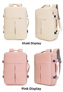Detail view of khaki and pink travel backpacks featuring waterproof fabric and side handles