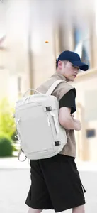 Outdoor shot of a man wearing a light grey urban business backpack in a city street