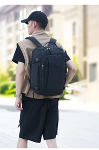 Detailed side view of a large black tactical backpack showing multiple zippers and side buckles