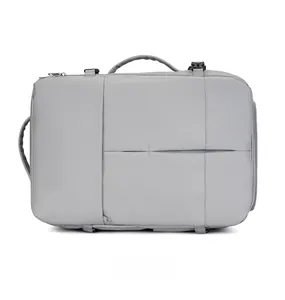 Detail view of the thick side handle and buckles on the grey travel business backpack
