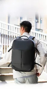 Modern black business backpack shown on model with street style city background