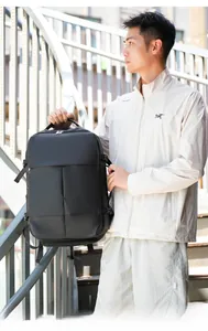 Detail of large black business backpack with buckle straps on metal stairs outdoor