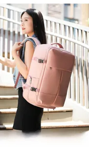 Pink travel backpack with adjustable side straps shown on person climbing stairs outdoors